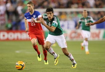 GLENDALE, AZ - APRIL 02:  Raul Jimenez #9 of Mexico controls the ball past Clarence Goodson #21 of USA during the International Friendly at University of Phoenix Stadium on April 2, 2014 in Glendale, Arizona. Mexico and USA played to a 2-2 tie.  (Photo by