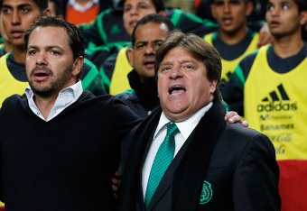 AMSTERDAM, NETHERLANDS - NOVEMBER 12:  Mexico Head Coach / Manager, Miguel Herrera (R) and his staff sing the national anthem prior to the international friendly match between Netherlands and Mexico held at the Amsterdam ArenA on November 12, 2014 in Amst