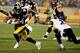 PITTSBURGH, PA - JANUARY 03: Antonio Brown #84 of the Pittsburgh Steelers avoids a tackle by Lardarius Webb #21 of the Baltimore Ravens during their AFC Wild Card game at Heinz Field on January 3, 2015 in Pittsburgh, Pennsylvania. (Photo by Justin K. A