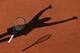 The shadow of Serena Williams as she throws her racket to celebrate winning the 2015 French Open.