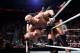 Cesaro clotheslines Viktor out of the ring.