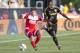 Jun 24, 2015; Columbus, OH, USA; New England Revolution midfielder Kelyn Rowe (11) tries to keep Columbus Crew SC defender Waylon Francis (14) off the ball at MAPFRE Stadium. Mandatory Credit: Greg Bartram-USA TODAY Sports