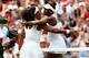 LONDON, ENGLAND - JULY 06: Serena Williams of the United States hugs Venus Williams of the United States after their Ladies' Singles Fourth Round match during day seven of the Wimbledon Lawn Tennis Championships at the All England Lawn Tennis and Croque