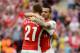 LONDON, ENGLAND - AUGUST 10: Calum Chambers of Arsenal is hugged by team-mate Mathieu Debuchy of Arsenal during the FA Community Shield match between Manchester City and Arsenal at Wembley Stadium on August 10, 2014 in London, England. (Photo by Ross Kin