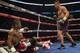 French-Cameroonian boxer Hassan N'Dam goes down for the 2nd time in the 4th round against Canadian David Lemieux as they battle for the IBF world middleweight championship in Montreal, Canada, on June 20, 2015. AFP PHOTO/PETER MCABE (Photo credit s