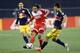 May 2, 2015; Foxborough, MA, USA; New England Revolution midfielder Jermaine Jones (13) passes the ball while defended by New York Red Bulls midfielder Sacha Kljestan (16) and defender Karl Ouimette (22) during the first half at Gillette Stadium. Mandato