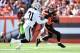 Browns wide receiver Brian Hartline makes a catch with Raiders cornerback Neiko Thorpe in coverage.