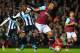 Newcastle United's Dutch midfielder Georginio Wijnaldum (L) vies against West Ham United's New Zealand defender Winston Reid during the English Premier League football match between West Ham United and Newcastle United at The Boleyn Ground in Upton Park,