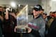 Epstein raises the World Series trophy in the Red Sox clubhouse in 2004.