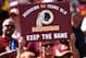 LANDOVER, MD - SEPTEMBER 14: A Washington Redskins fan holds up a sign to keep the Redskins name before they play the Jacksonville Jaguars at FedExField on September 14, 2014 in Landover, Maryland. The Washington Redskins won, 41-10. (Photo by Patrick Smi
