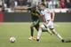 Nov 1, 2015; Portland, OR, USA; Portland Timbers midfielder Darlington Nagbe (6) runs after a ball as he is guarded by Vancouver Whitecaps midfielder Matias Laba (15) during the first half of an MLS playoff game at Providence Park. The game ended 0-0. Man