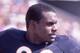 TAMPA, FL - OCTOBER 6: Safety Dave Duerson #22 of the Chicago Bears keeps his eys on the play action even though he is standing near the bench area in a NFL game against the Tampa Bay Buccaneers at Tampa Stadium on October 6, 1985 in Tampa, Florida. The B
