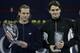 SHANGHAI - NOVEMBER 20: David Nalbandian of Argentina holds the trophy as Roger Federer looks on after his five set victory against Roger Federer of Switzerland in the final at the Qi Zhong Stadium , November 20, 2005 in Shanghai, China. (Photo by Clive