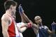 Athens, GREECE: Yan Barthelemy Varela (R) of of Cuba is declared winner over Moo Won Hong (L) of South Korea in their light flyweight (48 kg) quarter-final of the Olympic Games 24 August 2004 at the Peristeri Boxing Hall in Athens. AFP PHOTO / JOE KLAMA