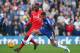 LONDON, ENGLAND - OCTOBER 31: Kenedy of Chelsea and Christian Benteke of Liverpool compete for the ball during the Barclays Premier League match between Chelsea and Liverpool at Stamford Bridge on October 31, 2015 in London, England. (Photo by Clive Rose
