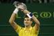 Novak Djokovic of Serbia celebrates winning his tennis match against Dustin Brown of Germany in the Qatar Open competition on January 4, 2016, in Doha. Djokovic won the match 6-2, 6-2. AFP PHOTO / KARIM JAAFAR / AFP / KARIM JAAFAR (Photo credit sho