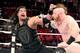Roman Reigns measures Sheamus for a right hand.