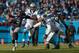 CHARLOTTE, NC - JANUARY 17: Russell Wilson #3 of the Seattle Seahawks scrambles from Kawann Short #99 of the Carolina Panthers in the 2nd quarter during the NFC Divisional Playoff Game at Bank of America Stadium on January 17, 2016 in Charlotte, North C