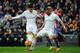 Real Madrid's Colombian midfielder James Rodriguez (L) and Real Madrid's French forward Karim Benzema try to control the ball during the Spanish league football match Real Madrid CF vs Real Sporting de Gijon at the Santiago Bernabeu stadium in Madrid on J