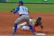 Infielder Neftali Soto of Puerto Rico makes an out on first base against Felix Perez of Venezuela during their 2016 Caribbean baseball series game on February 1, 2016 in Santo Domingo. AFP PHOTO/YAMIL LAGE / AFP / YAMIL LAGE (Photo credit should