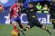 MADRID, SPAIN - JANUARY 24: Luciano Vietto of Club Atletico de Madrid is tackled by Ever Banega of Sevilla FC during the La Liga match between Club Atletico de Madrid and Sevilla FC at Vicente Calderon Stadium on January 24, 2016 in Madrid, Spain. (Pho