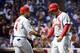 CHICAGO, IL - OCTOBER 12: Matt Holliday #7 of the St. Louis Cardinals is congratulated by Yadier Molina #4 of the St. Louis Cardinals after scoring a run in the fourth inning against the Chicago Cubs during game three of the National League Division Seri