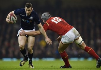 Scotland's centre Mark Bennett is tacked by Wales' centre Jonathan Davies during the Six Nations international rugby union match between Wales and Scotland at the Principality Stadium in Cardiff, south Wales, on February 13, 2016. / AFP / PAUL ELLIS / RES