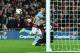 Liverpool's Belgian goalkeeper Simon Mignolet (R) saves a close-range shot from Manchester City's Argentinian striker Sergio Aguero (L) in extra time during the English League Cup final football match between Liverpool and Manchester City at Wembley Stadi