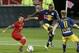 Oct 14, 2015; Toronto, Ontario, CAN; Toronto FC forward Sebastian Giovinco (10) works the ball around New York Red Bulls defender Ronald Zubar (23) and midfielder Dax McCarty (11) before scoring at BMO Field. Toronto defeated New York 2-1. Mandatory Credi