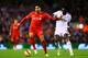 LIVERPOOL, ENGLAND - DECEMBER 29: Emre Can of Liverpool battles for the ball with Bafetibis Gomis of Swansea City during the Barclays Premier League match between Liverpool and Swansea City at Anfield on December 29, 2014 in Liverpool, England. (Photo b