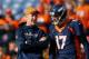 DENVER, CO - DECEMBER 13: Injured quarterback Peyton Manning of the Denver Broncos, left, has a word with quarterback Brock Osweiler #17 as players warm up before a game against the Oakland Raiders at Sports Authority Field at Mile High on December 13, 2