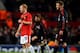 MANCHESTER, ENGLAND - MARCH 10: Paul Scholes (L) of Manchester United shares a joke with David Beckham of AC Milan during the UEFA Champions League First Knockout Round, second leg match between Manchester United and AC Milan at Old Trafford on March 10,