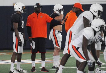 Auburn WR coach Kodi Burns (center)