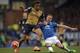 Jagielka attempts to stop Arsenal's Alex Iwobi.
