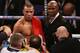British boxer Chris Eubank Jr (L) and his father and manager English, aka former boxing champion Chris Eubank Snr pose for photographers in the ring after Eubank Jr won his non-title middleweight boxing match against Irish boxer Gary 'Spike' O'Sullivan (N