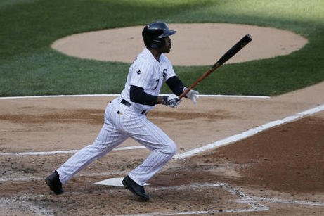 Chicago White Sox's Jimmy Rollins, front, throws his bat after