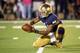 Sep 5, 2015; South Bend, IN, USA; Notre Dame Fighting Irish quarterback DeShone Kizer (14) handles the snap as holder on a place kick in the fourth quarter against the Texas Longhorns at Notre Dame Stadium. Notre Dame won 38-3. Mandatory Credit: Matt Cash