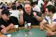 LAS VEGAS - JULY 30: Poker player Greg 'Fossilman' Raymer (C), the 2004 World Series of Poker champion, celebrates winning a hand as Keith Plemons (L) and Fabio Cunha (R) look on during the third day of the first round of the WSOP no-limit Texas Hold 'em