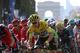 Great Britain's Christopher Froome (C), wearing the overall leader's yellow jersey and Colombia's Nairo Quintana (3Rd R) ride in the pack near the Arc de Triomphe (Arch of triumph) during the 113 km twenty-first and last stage of the 103rd edition of the