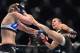 Justino (right) kicks Leslie Smith at UFC 198.