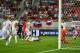 TRNAVA, SLOVAKIA - SEPTEMBER 04: Adam Lallana of England (obscured) shoots past goalkeeper Matus Kozacik of Slovakia to score their first goal during the 2018 FIFA World Cup Group F qualifying match between Slovakia and England at City Arena on September