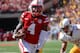 LINCOLN, NE - SEPTEMBER 10: Quarterback Tommy Armstrong Jr. #4 of the Nebraska Cornhuskers avoids the tackle of linebacker D.J. May #7 of the Wyoming Cowboys to score at Memorial Stadium on September 10, 2016 in Lincoln, Nebraska. (Photo by Steven Bransco