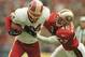 24 Nov 1996: Safety Tim McDonald #46 of the San Francisco 49ers tries to pull down Washington Redskins tight end #84 Jamie Asher during the second quarter at RFK Stadium in Washington, D.C.