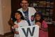 Shapiro celebrating the Game 2 victory with two of his daughters and the Cubs' "W" flag