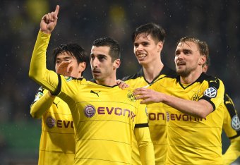 Dortmund's Armenian midfielder Henrikh Mkhitaryan (2ndL)and teammates celebrate after a second goal during the German Cup DFB Pokal third round match between Borussia Dortmund and FC Augsburg in Augsburg on December 16, 2015.  / AFP / Christof STACHE / RE