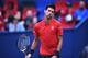 Novak Djokovic of Serbia reacts after a missed return against Mischa Zverev of Germany during their men's singles match at the Shanghai Masters tennis tournament on October 14, 2016. / AFP / JOHANNES EISELE (Photo credit should read JOHANNES EISELE