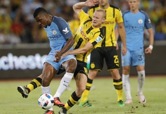 SHENZHEN, CHINA - JULY 28: Kelechi Iheanacho (#72) of Manchester City contests the ball against Sebastian Rode of Borussia Dortmund during the 2016 International Champions Cup match between Manchester City and Borussia Dortmund at Shenzhen Universiade St