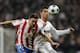 Tomas Ujfalusi nips in ahead of Cristiano Ronaldo.