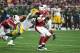 GLENDALE, AZ - JANUARY 16: Outside linebacker Julius Peppers #56 of the Green Bay Packers hits quarterback Carson Palmer #3 of the Arizona Cardinals during the first half of the NFC Divisional Playoff Game at University of Phoenix Stadium on January 16, 2