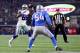 ARLINGTON, TX - DECEMBER 26: Dez Bryant #88 of the Dallas Cowboys throws a touchdown pass to Jason Witten #82 of the Dallas Cowboys against DeAndre Levy #54 of the Detroit Lions in the third quarter at AT&T Stadium on December 26, 2016 in Arlington, Texa